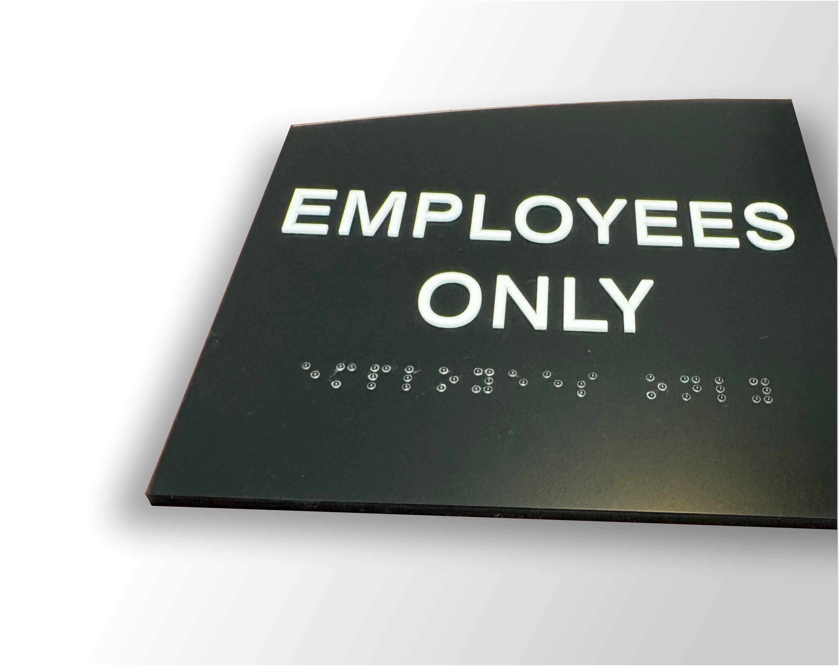 Crescent ADA braille sign with curved top design and raised tactile lettering